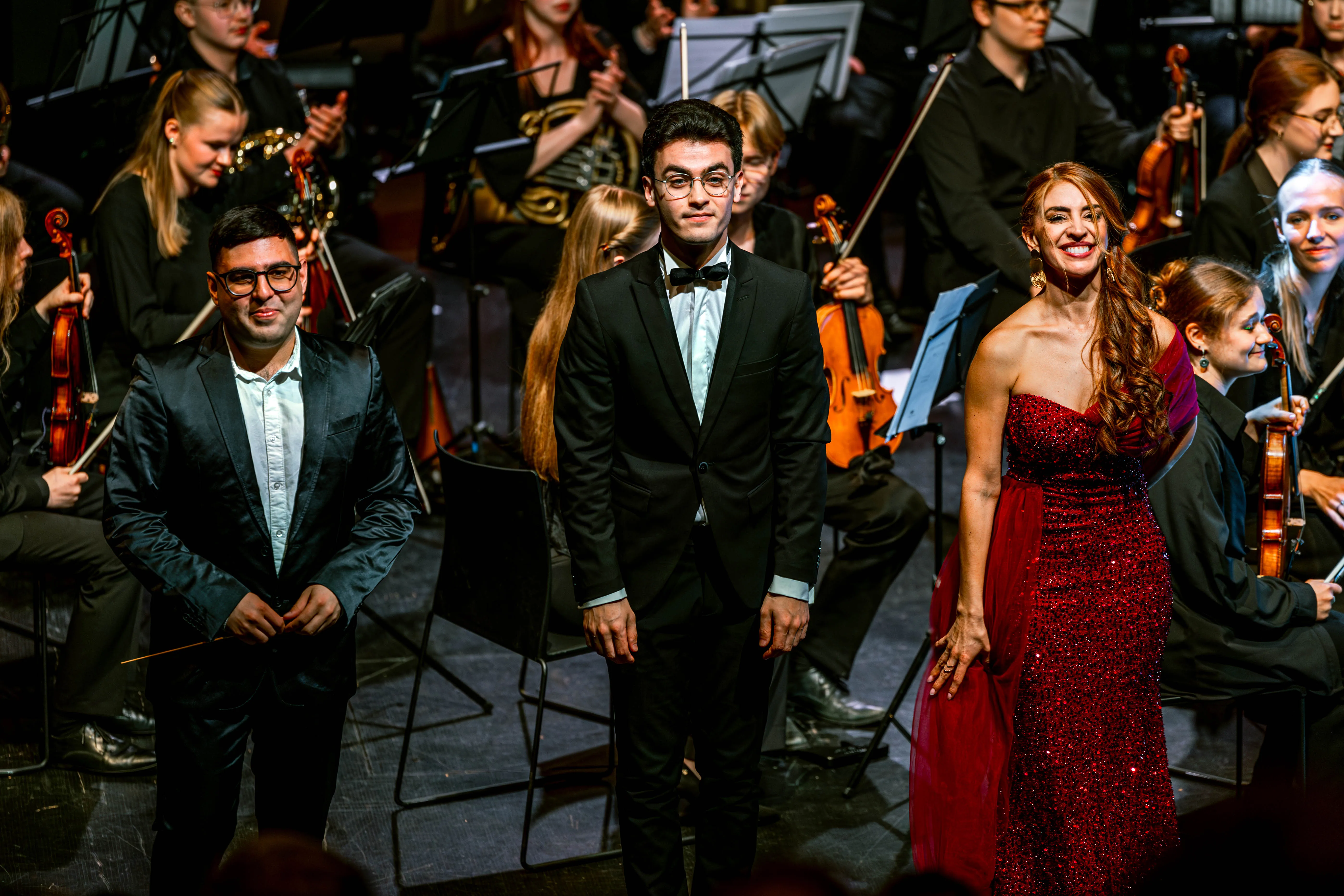 Eladio Aguilar taking a bow with soloists at Iberofest 2025, Kumu Auditorium